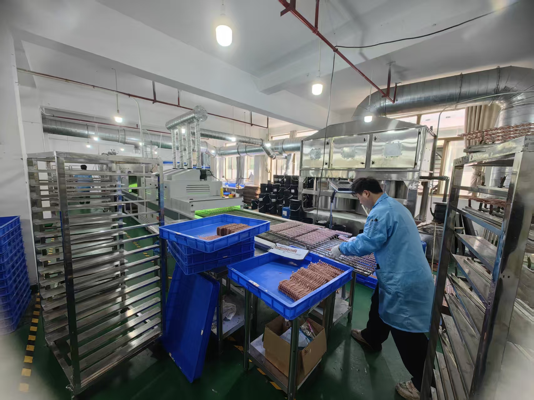 Worker inspecting nail tips at a production station